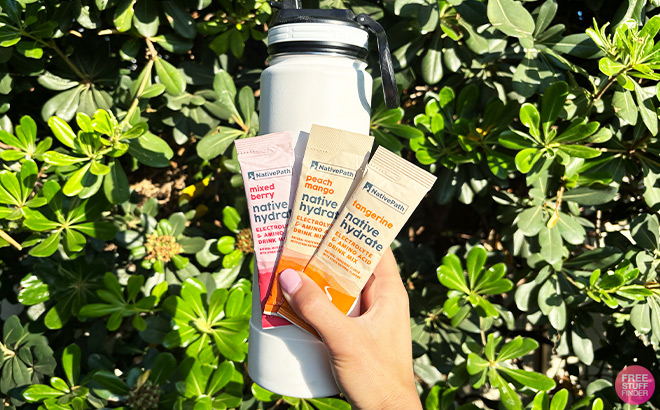 A Person Holding a Water Bottle and Three Hydrate Packs A Person Holding a Water Bottle and Three Hydrate Packs