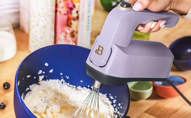 A Person Holding Beautiful by Drew Barrymore 6 Speed Electric Hand Mixer