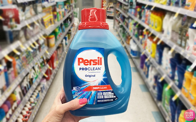 A Person Holding Persil Deep Clean Liquid Laundry Detergent