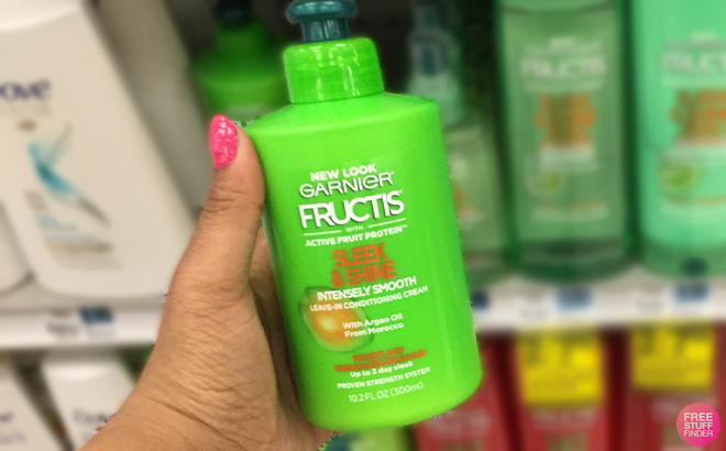 A Person Holding the Garnier Fructis Sleek Shine Intensely Smooth Leave In Conditioning Cream