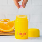 A Person Taking out a Vitamin out of a Hiya Box