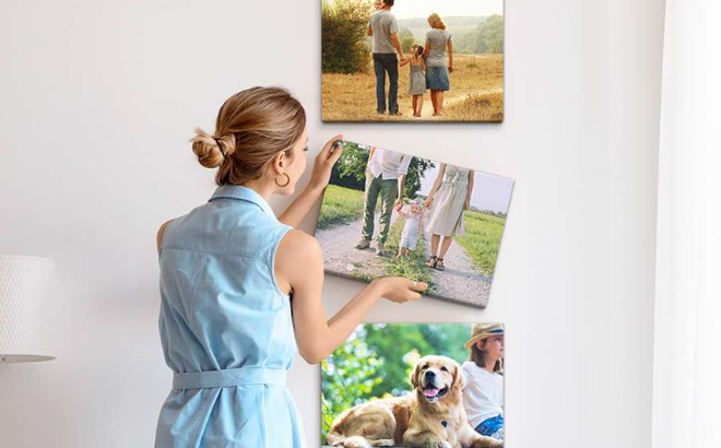 A Woman Hanging a Custom Canvas Print on a Wall