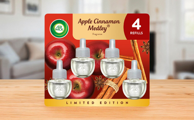 Air Wick Plug In Scented Oil Refill in Apple Cinnamon Medley Scent 4 Pack on the Table