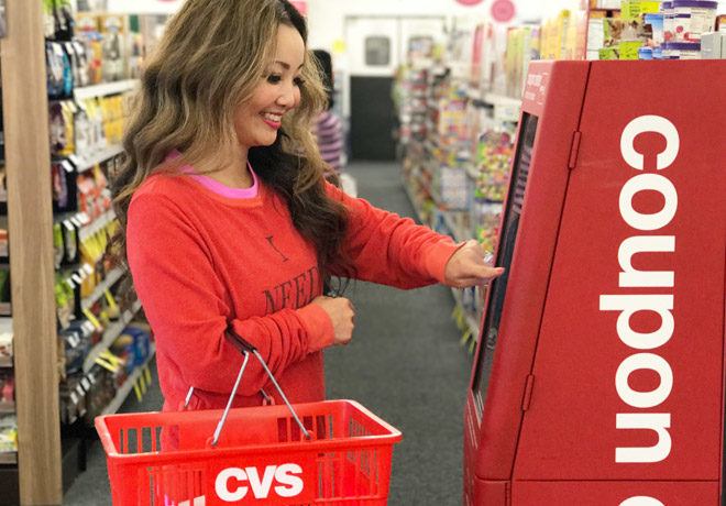 A Smiling Woman at the Red Coupon Machine at CVS A Smiling Woman at the Red Coupon Machine at CVS