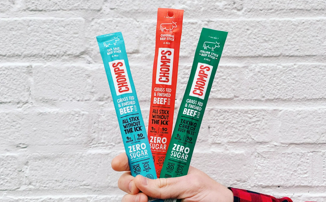 Hand Holding Chomps Beef Jerkey Sticks